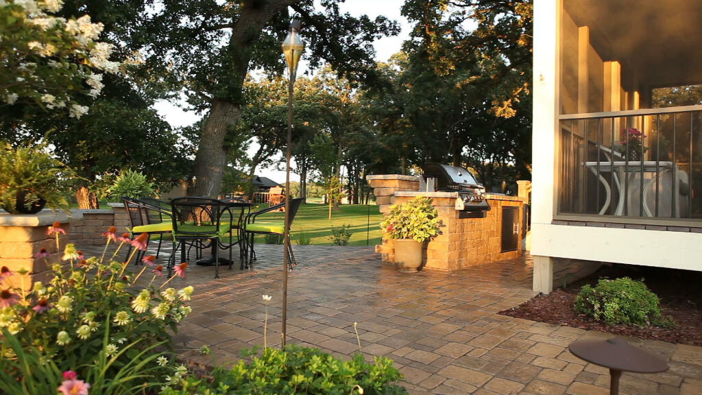 Outdoor Kitchen and Dining Area by Sequoia Landscape